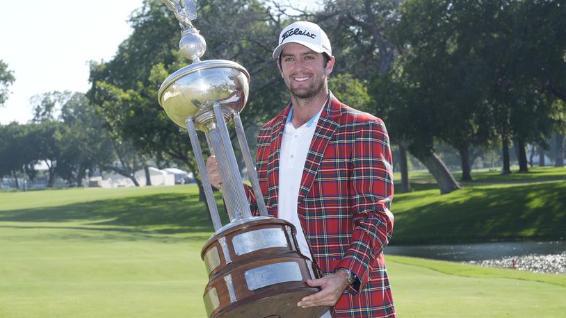 Davis Riley poses with the winner's trophy at the Charles Schwab Challenge golf tournament at Colonial Country Club in Fort Worth, Texas, Sunday, May 26, 2024. (AP Photo/LM Otero