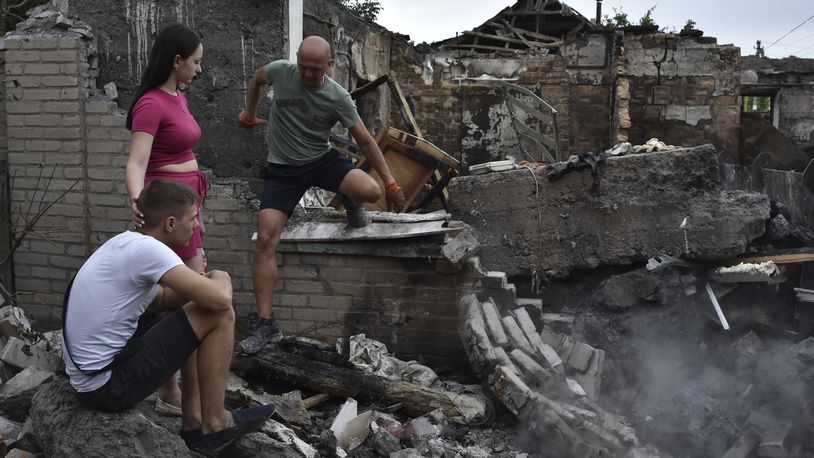 A couple sit in front of their house destroyed by a Russian strike in Zaporizhzhia, Ukraine, Tuesday, Aug. 27, 2024. (AP Photo/Andriy Andriyenko)