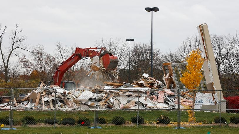 A demolition crew tears down a building in front of the Kohl's department store in the Bechtle Crossing shopping center Tuesday, Nov. 1, 2022. The site will become home to a Panda Express restaurant. BILL LACKEY/STAFF