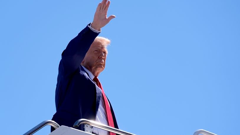 Republican presidential nominee former President Donald Trump waves as he boards a plane at Harry Reid International Airport after a campaign trip, Saturday, Sept.14, 2024, in Las Vegas. (AP Photo/Alex Brandon)