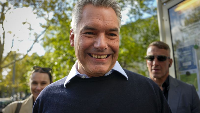 Austrian Chancellor Karl Nehammer smiles upon arriving at a polling station in Vienna, Austria, Sunday, Sept. 29, 2024, to cast his vote in the country's national election. (AP Photo/Andreea Alexandru)