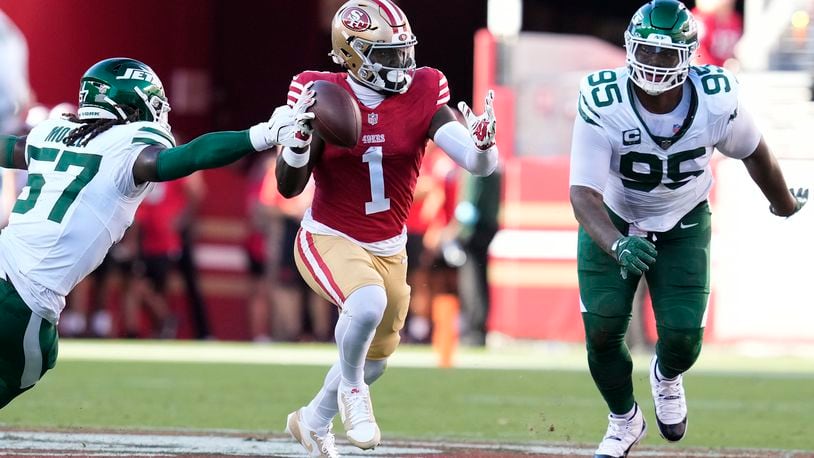 San Francisco 49ers wide receiver Deebo Samuel Sr. (1) runs between New York Jets linebacker C.J. Mosley and defensive tackle Quinnen Williams (95) during the first half of an NFL football game in Santa Clara, Calif., Monday, Sept. 9, 2024. (AP Photo/Godofredo A. Vásquez)