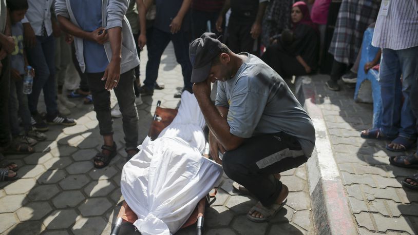 Palestinians mourn over the bodies of relatives killed in an Israeli airstrike, outside the morgue in Al-Aqsa Martyrs Hospital in Deir al Balah, the Gaza Strip, Monday, June 10, 2024. (AP Photo/Jehad Alshrafi)
