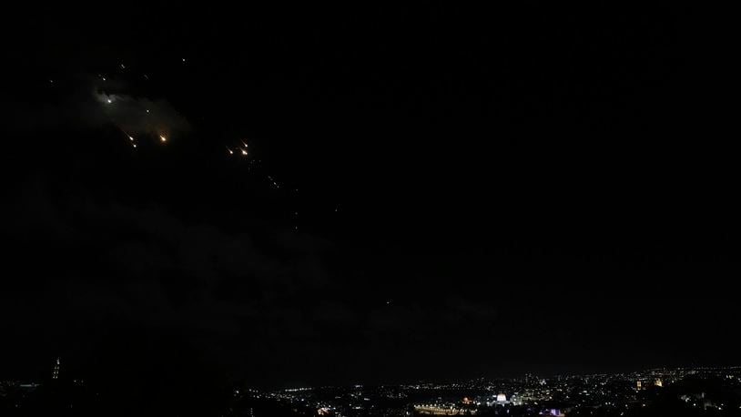 FILE - Rockets are seen over Jerusalem as a siren sounds a warning of incoming missiles fired from Iran, in Jerusalem, Tuesday, Oct. 1, 2024. (AP Photo/Mahmoud Illean, File)