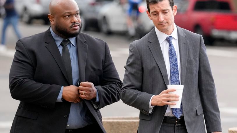 Former Memphis police officer Desmond Mills, left, arrives at the federal courthouse with his attorney Blake Ballin, right, to testify against his former colleagues during the trial in the Tyre Nichols case Wednesday, Sept. 25, 2024, in Memphis, Tenn. (AP Photo/George Walker IV)