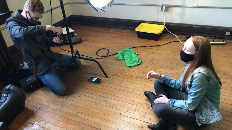 Kolton Rice, left, owner of OpenEye Studios, photographs Mary Cunningham for a series of posters that will be featured in an upcoming anti-vaping campaign being created by local youth service group B.A.T.S. Photo by Brett Turner