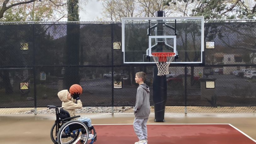 This undated photo provided by Jasculca Terman Strategic Communications shows twin brothers Cooper and Luke Roberts playing basketball. Cooper was a victim of the 2022 Fourth of July parade shooting in Highland Park, Ill., and remains paralyzed from the waist down. Keely Roberts, the mother of the youngest victims of the Fourth of July parade shooting, which left one of her twin sons — now 10 — paralyzed from the waist down, will talk to the media Wednesday, July 3, 2024, about what it means to survive the horror two years later. (The Roberts Family/Jasculca Terman Strategic Communications via AP)