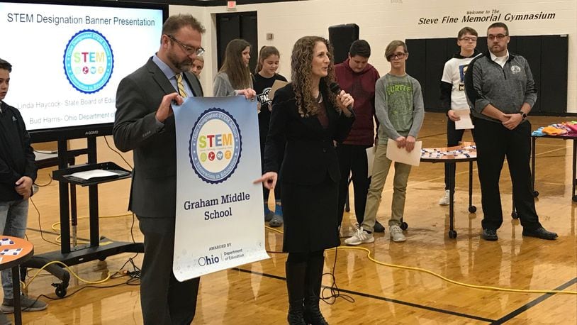 Linda Haycock, Ohio Board of Education Member, presents a STEM award to Graham Local Schools for developing and excellence in Science, Technology, Engineering, and Mathematics curriculum. ERIC HIGGENBOTHAM/STAFF