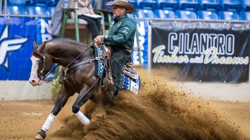 Clark County resident Shawn Flarida is shown doing the slide maneuver in a horse show. Flarida, owner of Shawn Flarida Reiners in Springfield, has earned $8 million competing with reining horses, having won every major event in the industry. CHELSEA SCHNEIDER MEDIA