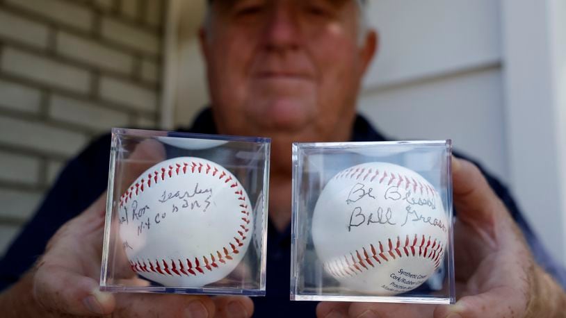 John Leep, organizer of Stevie's World of Wiffle Ball, holds two baseballs that were autographed by Negro League baseball players Ron Teasley and Bill Greason. The ball will be auctioned at the annual Wiffle Ball Tournament. BILL LACKEY/STAFF