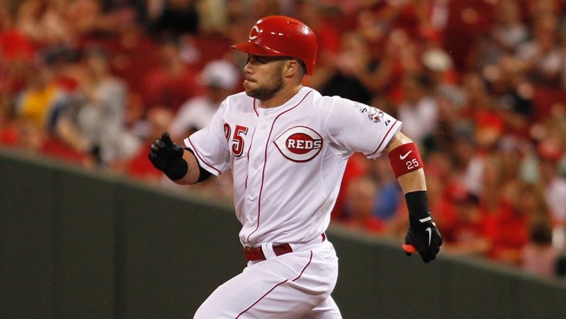 The Reds' Skip Schumaker heads to second with a double in the fifth inning Monday, July 7, 2014, at Great American Ball Park in Cincinnati.