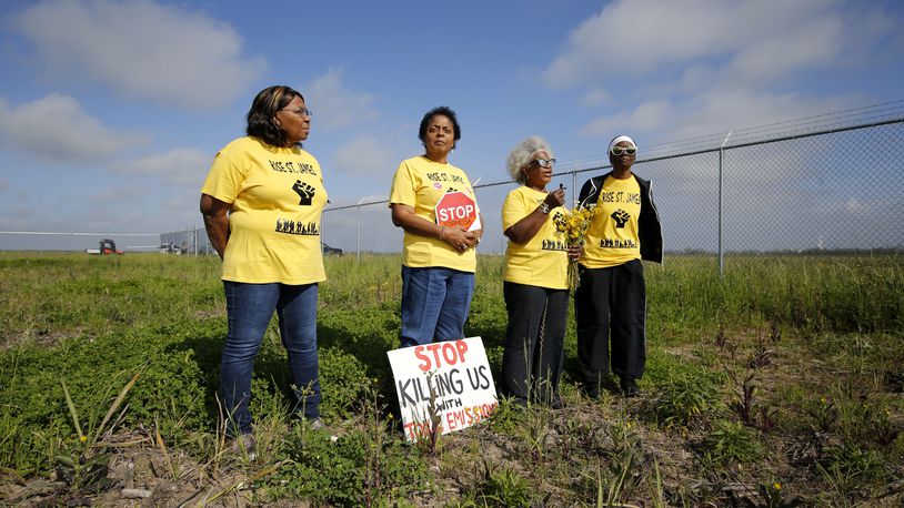 FILE - From left, Myrtle Felton, Sharon Lavigne, Gail LeBoeuf and Rita Cooper, members of RISE St. James, conduct a live stream video on property owned by Formosa in St. James Parish, La., Wednesday, March 11, 2020. (AP Photo/Gerald Herbert, File)