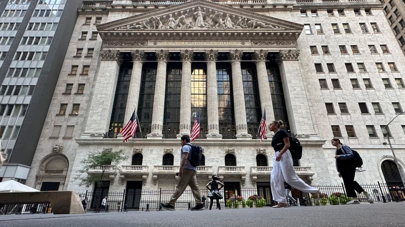 People pass the New York Stock Exchange on Wednesday, Sept. 4, 2024, in New York. (AP Photo/Peter Morgan)