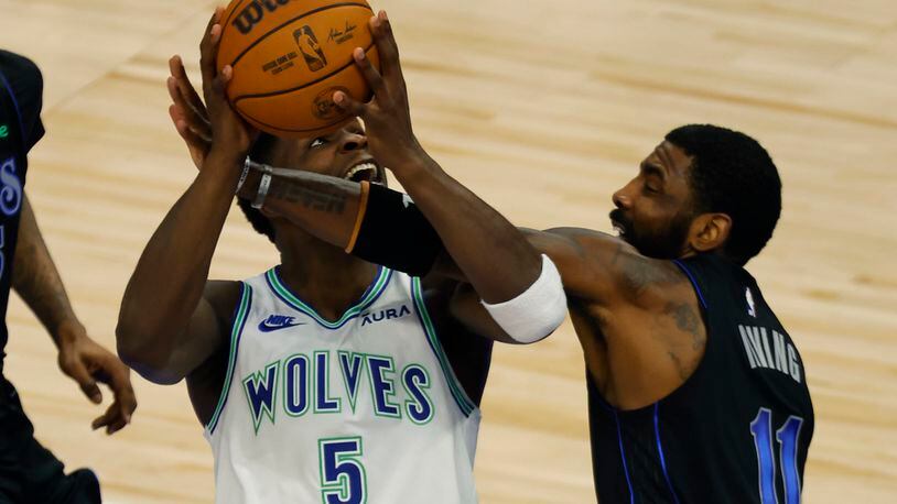 Dallas Mavericks guard Kyrie Irving (11) guards Minnesota Timberwolves guard Anthony Edwards (5) during the first half of Game 2 of the NBA basketball Western Conference finals, Friday, May 24, 2024, in Minneapolis. (AP Photo/Bruce Kluckhohn)