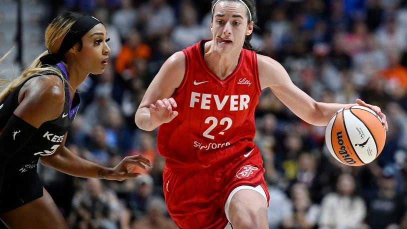 Indiana Fever guard Caitlin Clark (22) drives to the basket as Connecticut Sun guard DiJonai Carrington defends during a first-round WNBA basketball playoff game, Wednesday, Sept. 25, 2024, in Uncasville, Conn. (AP Photo/Jessica Hill)