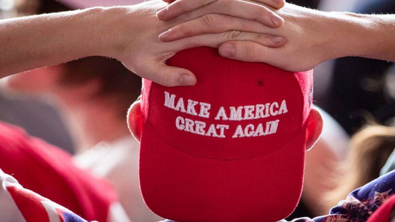 Two boys wearing pro-Trump hats were angered when the hats' slogans were blurred out of a high school yearbook photo.