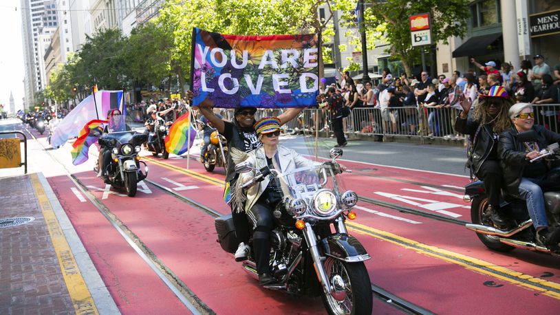 FILE - Bikers, center, ride a Harley Davidson motorcycle in the annual Pride Parade in San Francisco June 30, 2024. (Minh Connors/San Francisco Chronicle via AP)