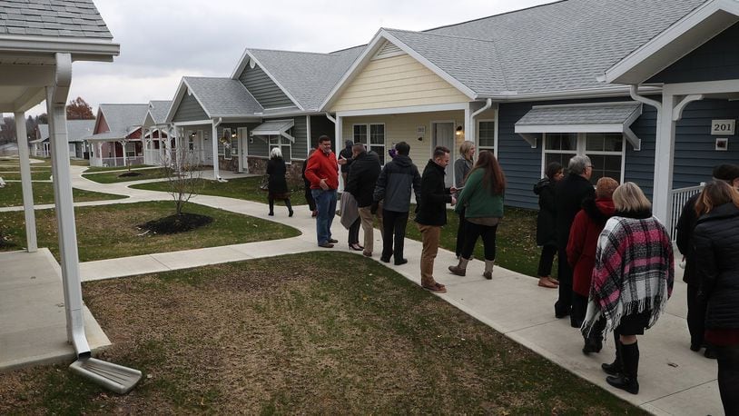 Visitors tour Community Gardens, a senior housing development located where Community Hospital used to be. The 50 unit pocket neighborhood was completed in 2018. Its developers are working on a plan that would add 60-more units there. BILL LACKEY/STAFF