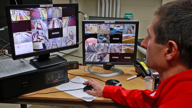 Brian Dixon, director of facilities and safety at Tecumseh Schools, looks over the video feeds from the school's security cameras Thursday, Dec. 1, 2022. BILL LACKEY/STAFF