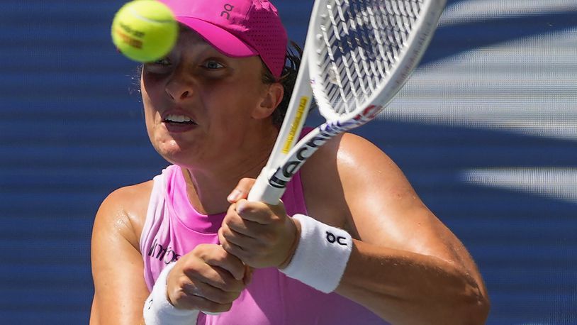 Iga Swiatek, of Poland, returns a shot to Kamilla Rakhimova, during the first round of the U.S. Open tennis championships, Tuesday, Aug. 27, 2024, in New York. (AP Photo/Kirsty Wigglesworth)