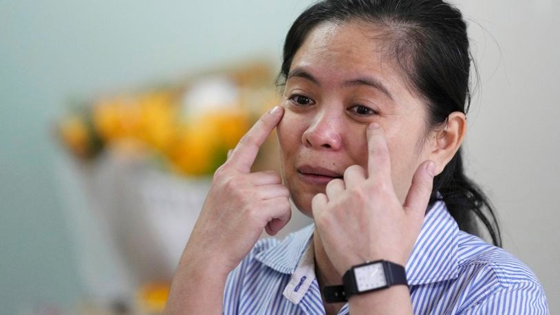 Chhim Sithar, president of the Labor Rights Supported Union of Khmer Employees of NagaWorld, gestures as she meets her supporters in a club at the outskirts of Phnom Penh Cambodia, Monday, Sept. 16, 2024, after the union leader was freed from prison on Monday after serving time for her part in a strike against the country's biggest casino. (AP Photo/Heng Sinith)