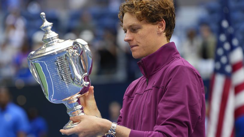 Jannik Sinner, of Italy, holds the championship trophy after defeating Taylor Fritz, of the United States, in the men's singles final of the U.S. Open tennis championships, Sunday, Sept. 8, 2024, in New York. (AP Photo/Kirsty Wigglesworth)