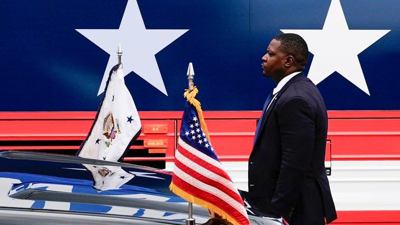 FILE - A U.S. Secret Service agent stands watch outside a campaign bus for Democratic presidential nominee Vice President Kamala Harris and her running mate Minnesota Gov. Tim Walz, Aug. 18, 2024, in Rochester, Pa. (AP Photo/Julia Nikhinson, File)