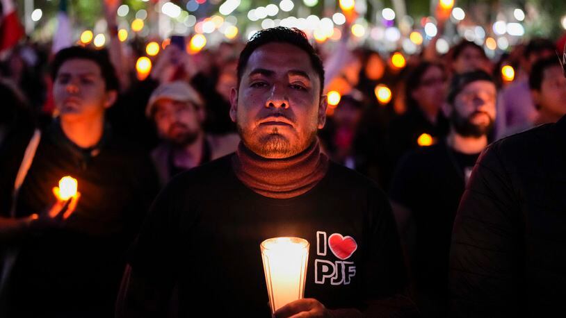 A unionized federal court worker protests against over reforms that would make all judges stand for election in Mexico City, Monday, Aug. 26, 2024. (AP Photo/Eduardo Verdugo)