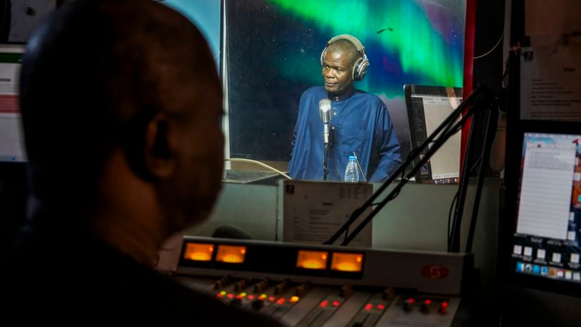 Maodo Faye, radio presenter at Sud FM, presents the afternoon Wolof program from the Sud FM studio in Dakar, Senegal, Wednesday, Oct. 2, 2024. (AP Photo/Annie Risemberg)