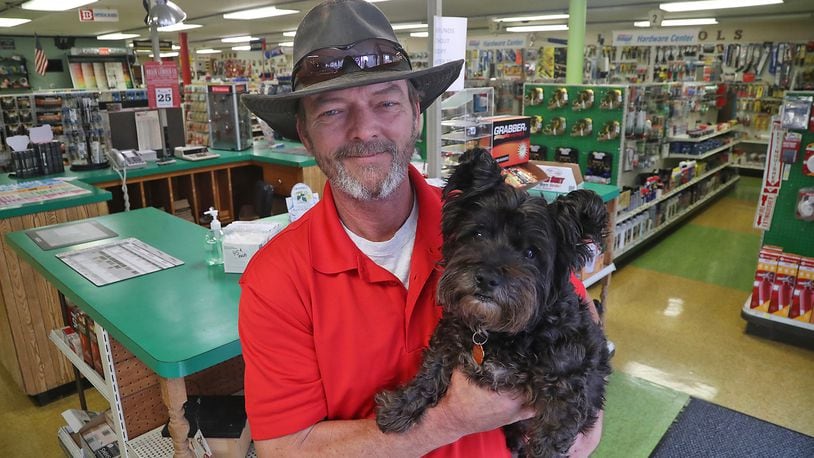 Brant Cornelison, the new owner of the Brain Lumber Company on East Street in Springfield, with "Charlie" in the hardware section of the business Wednesday, Oct. 26, 2022. Brant started working at the 154-year-old business when he was 14 years old. BILL LACKEY/STAFF