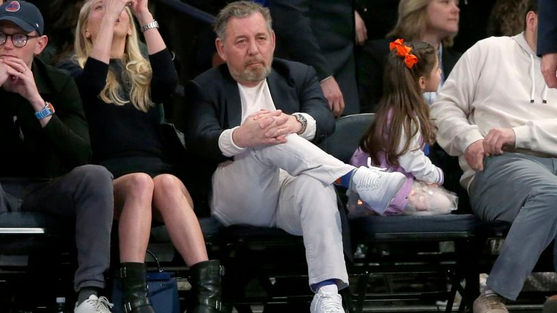 FILE - New York Knicks owner James Dolan, center, watches the second half of an NBA basketball game against the Chicago Bulls, April 14, 2024, in New York. (AP Photo/John Munson, File)