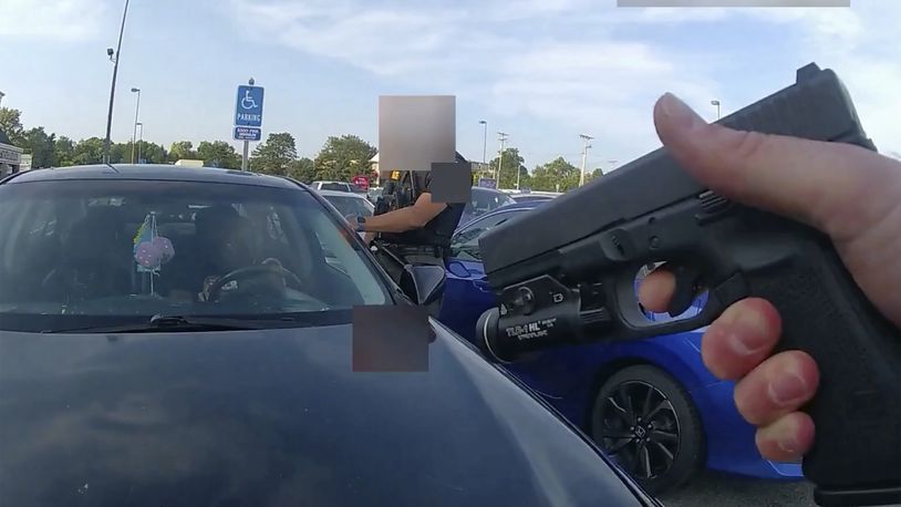 This still image from bodycam video released by the Blendon Township Police on Friday, Sept. 1, 2023, shows an officer pointing his gun at Ta'Kiya Young moments before shooting her through the windshield outside a grocery store in Blendon Township, Ohio, a suburb of Columbus, on Aug. 24. The video was pixelated by the source. (Blendon Township Police via AP, File)