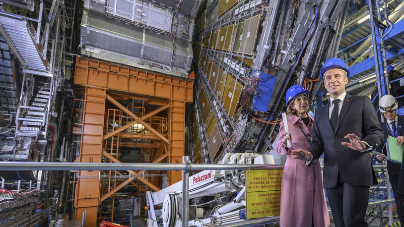 FILE - Fabiola Gianotti, left, Director General of the European Organization for Nuclear Research (CERN), and French President Emmanuel Macron, front, visit the ATLAS experiment, at the CERN (the European particle physics laboratory), in Meyrin near Geneva, Switzerland, Thursday, Nov. 16, 2023. (Martial Trezzini/Keystone via AP, Pool, File)