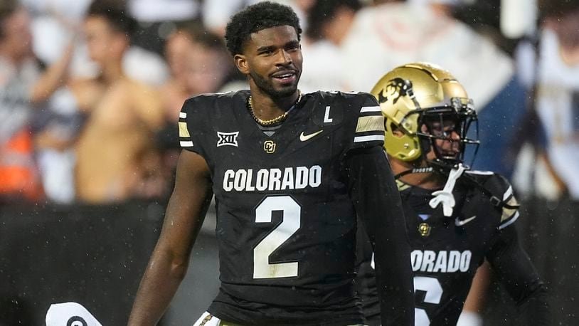 Colorado quarterback Shedeur Sanders, front, and wide receiver Drelon Miller celebrate after an overtime victory over Baylor in an NCAA college football game Saturday, Sept. 21, 2024, in Boulder, Colo. (AP Photo/David Zalubowski)