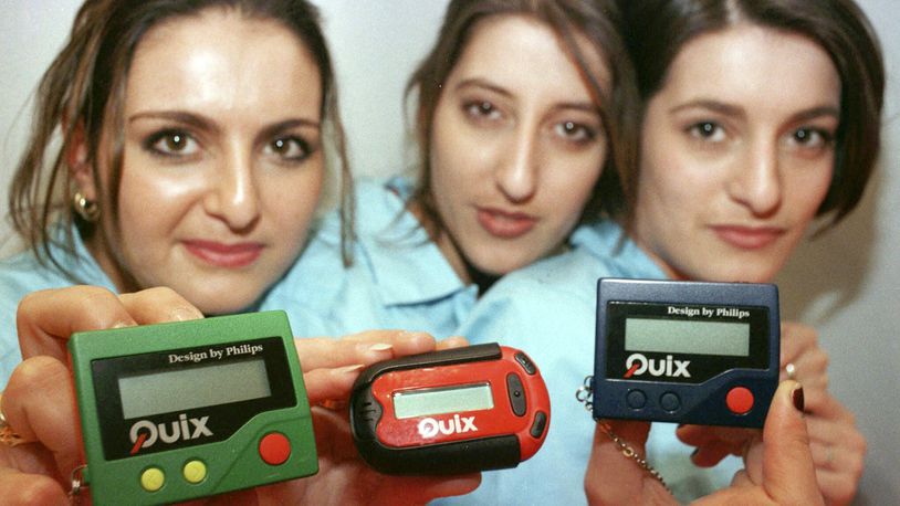 FILE - Three women hold the pager 'Quix' as they present it at CeBIT '97 in Hannover, Germany, Tuesday March 18, 1997. The beep-beep-beep of a small black box on your belt or in your pocket was something of a status symbol decades before the smartphone wiped it from popular culture. (AP Photo/Fabian Bimmer, File)