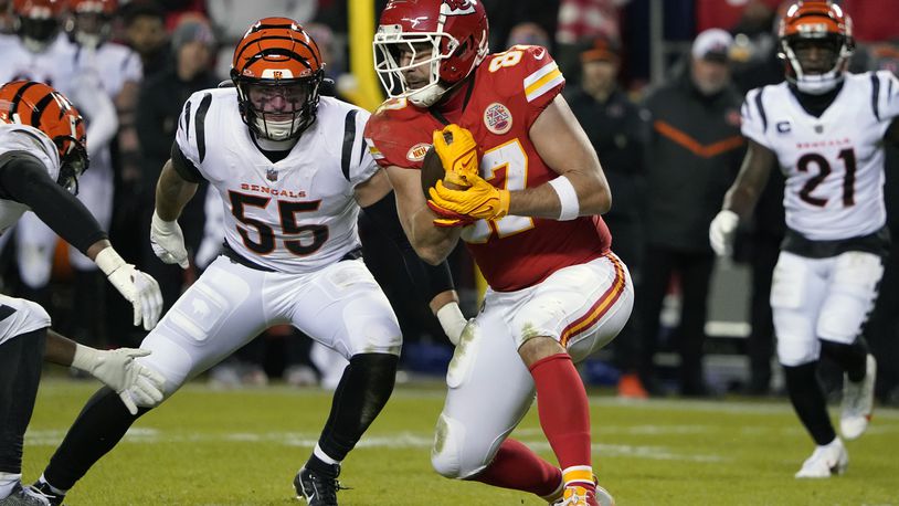 Kansas City Chiefs tight end Travis Kelce catches a pass as Cincinnati Bengals linebacker Logan Wilson (55) defends during the second half of an NFL football game Sunday, Dec. 31, 2023, in Kansas City, Mo. (AP Photo/Ed Zurga)