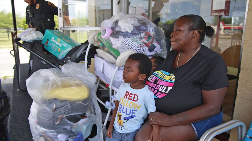 Roena Cole sits outside the office at the Executive Inn homeless shelter with all her grandson's belongings after being told she, her daughter and grandson had to leave Tuesday, August 6, 2024. BILL LACKEY/STAFF