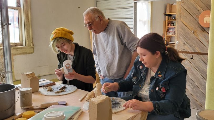 Maddie McCutcheon, right, and friend Robin Clingerman work with pottery expert Bruce Grimes preparing art they will sell at the Self-Love Art Showcase on Friday evening at the Hatch Artist Studios. Proceeds raised will go to Project Woman. Contributed photo