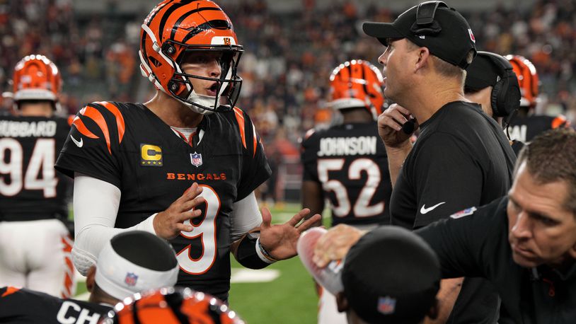 Cincinnati Bengals quarterback Joe Burrow (9) talks with head coach Zac Taylor, right, during the second half of an NFL football game against the Washington Commanders, Monday, Sept. 23, 2024, in Cincinnati. The Commanders won 38-33. (AP Photo/Jeff Dean)