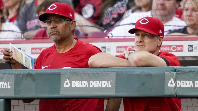 Cincinnati Reds manager David Bell, right, stands in the dugout with bench coach Freddie Benavides during the sixth inning of a baseball game against the St. Louis Cardinals Saturday, April 23, 2022, in Cincinnati. (AP Photo/Jeff Dean)