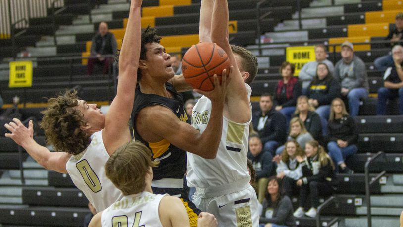 Shawnee's Zion Crowe is sandwiched by Botkins' Jacob Pleiman (right) and Carter Pleiman in the first half Sunday against Botkins in the Elk Elite Shoutout at Centerville High School. Jeff Gilbert/CONTRIBUTED