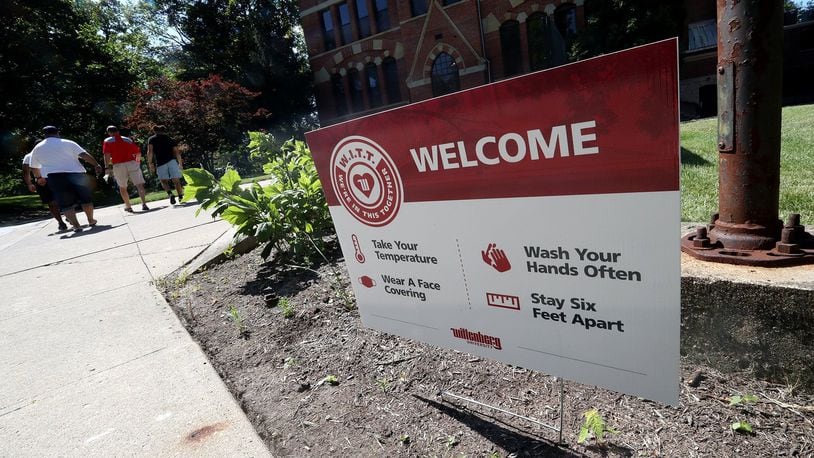 Signs, reminding visitors about Covid-19 precautions, are placed aroung the admissions office at Wittenberg Univsersity. BILL LACKEY/STAFF