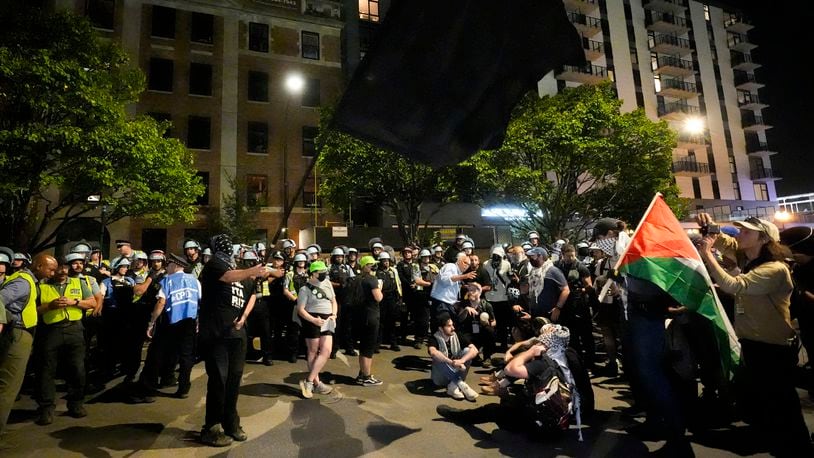 Protesters sit in the street during a demonstration near the Democratic National Convention Thursday, Aug. 22, 2024, in Chicago. (AP Photo/Alex Brandon)