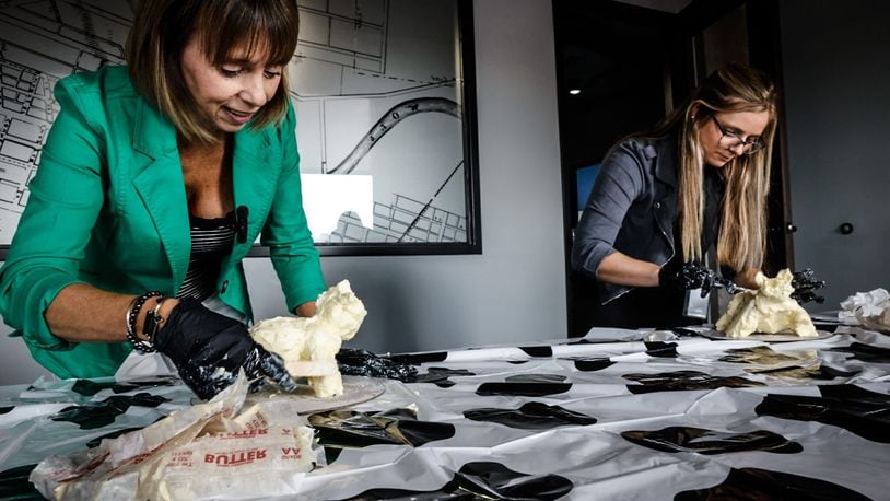 Food & Dining Reporter Natalie Jones (right) and Publisher Suzanne Klopfenstein (left) attempted to make their own butter cow in honor of the display at the Ohio State Fair. JIM NOELKER/STAFF