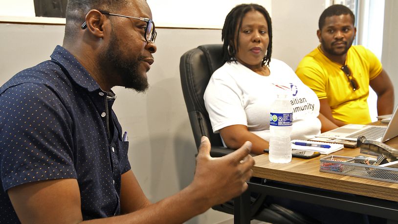 Viles Dorsainvil, left, talks about the Haitian Community Center, with fellow board members, Rose Thamar Joseph and Lindsay Aime Wednesday, June 5, 2024 at the community center on South Yellow Springs Street. BILL LACKEY/STAFF