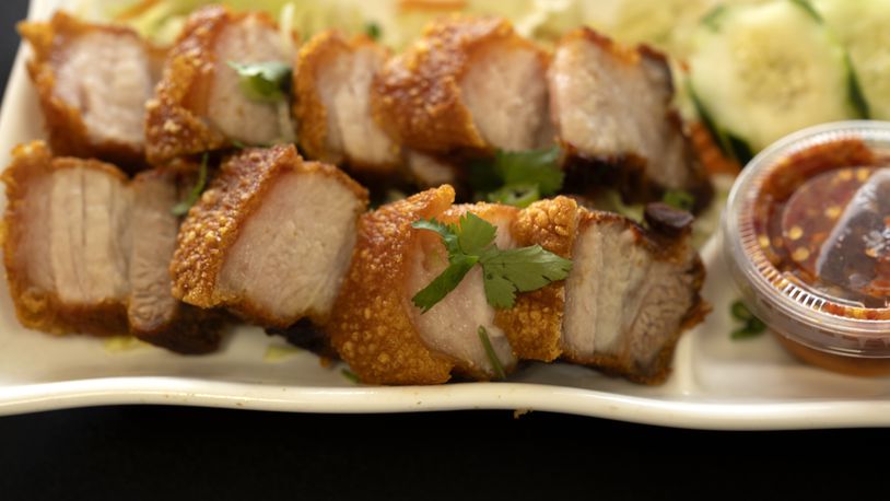 FILE - Crispy Pork Belly is presented at "Love & Thai" restaurant in Fresno, Calif., Wednesday, Dec. 20, 2023. The Thai restaurant, is back in operation after being wrongfully accused of abusing a dog to turn it into meat. It may be astonishing to some that a claim rooted in a racist stereotype took down a restaurant three years after "Stop Asian Hate" became a rallying cry. (AP Photo/Richard Vogel, File)