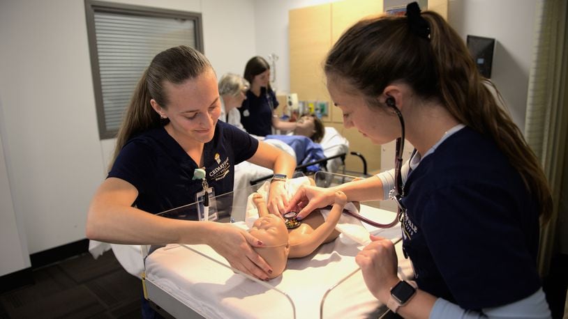 Cedarville University nursing students participate in a simulation with the school’s new mother and baby manikins. Contributed by Cedarville University/Photo by Scott Huck