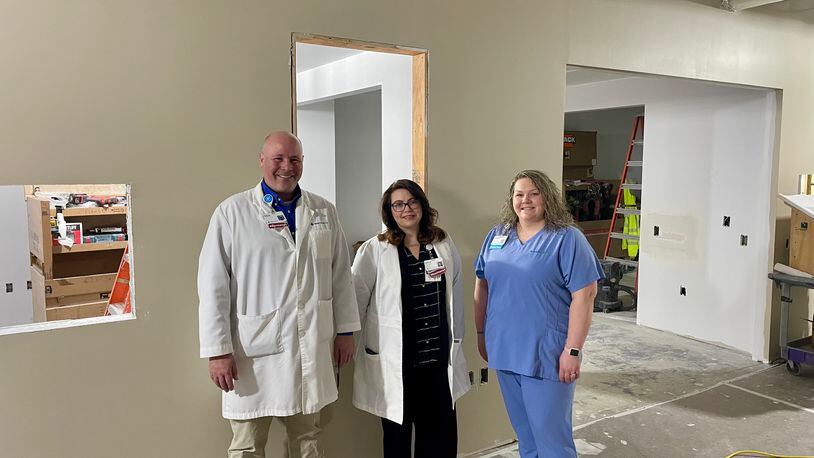 Lead pharmacist Chris Patsiavos, clinical pharmacist Ashlee Leaver and technician Amanda Castle are shown as construction is underway for the Mercy Health - Urbana Hospital pharmacy. CONTRIBUTED