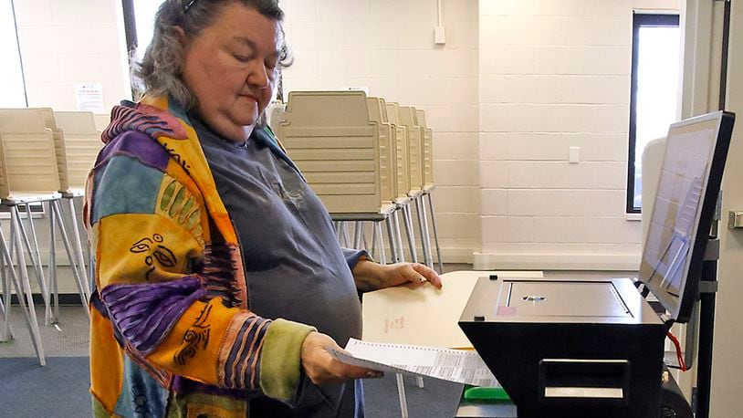 Jan Vaughan slides her ballot in the voting machine as she votes early at the Clark County Board of Elections Tuesday, March 12, 2024. BILL LACKEY/STAFF