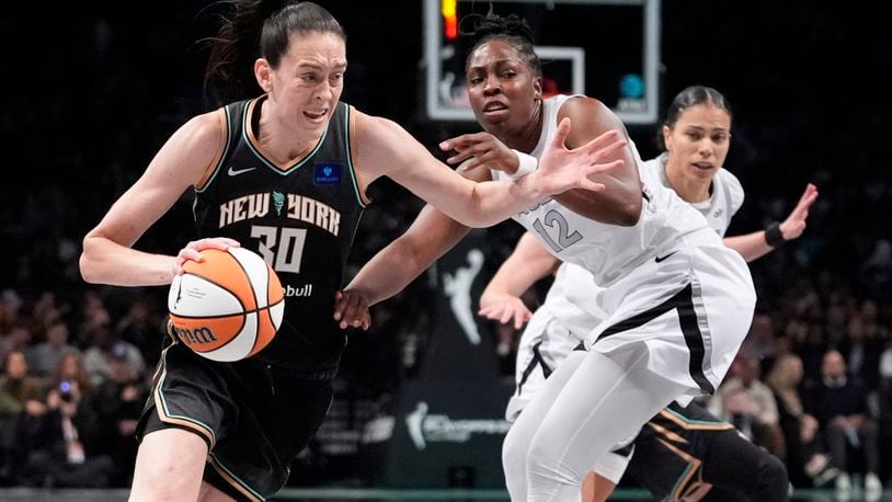 New York Liberty's Breanna Stewart (30) drives past Las Vegas Aces' Chelsea Gray (12) during the first half of a WNBA basketball semifinal game, Tuesday, Oct. 1, 2024, in New York. (AP Photo/Frank Franklin II)